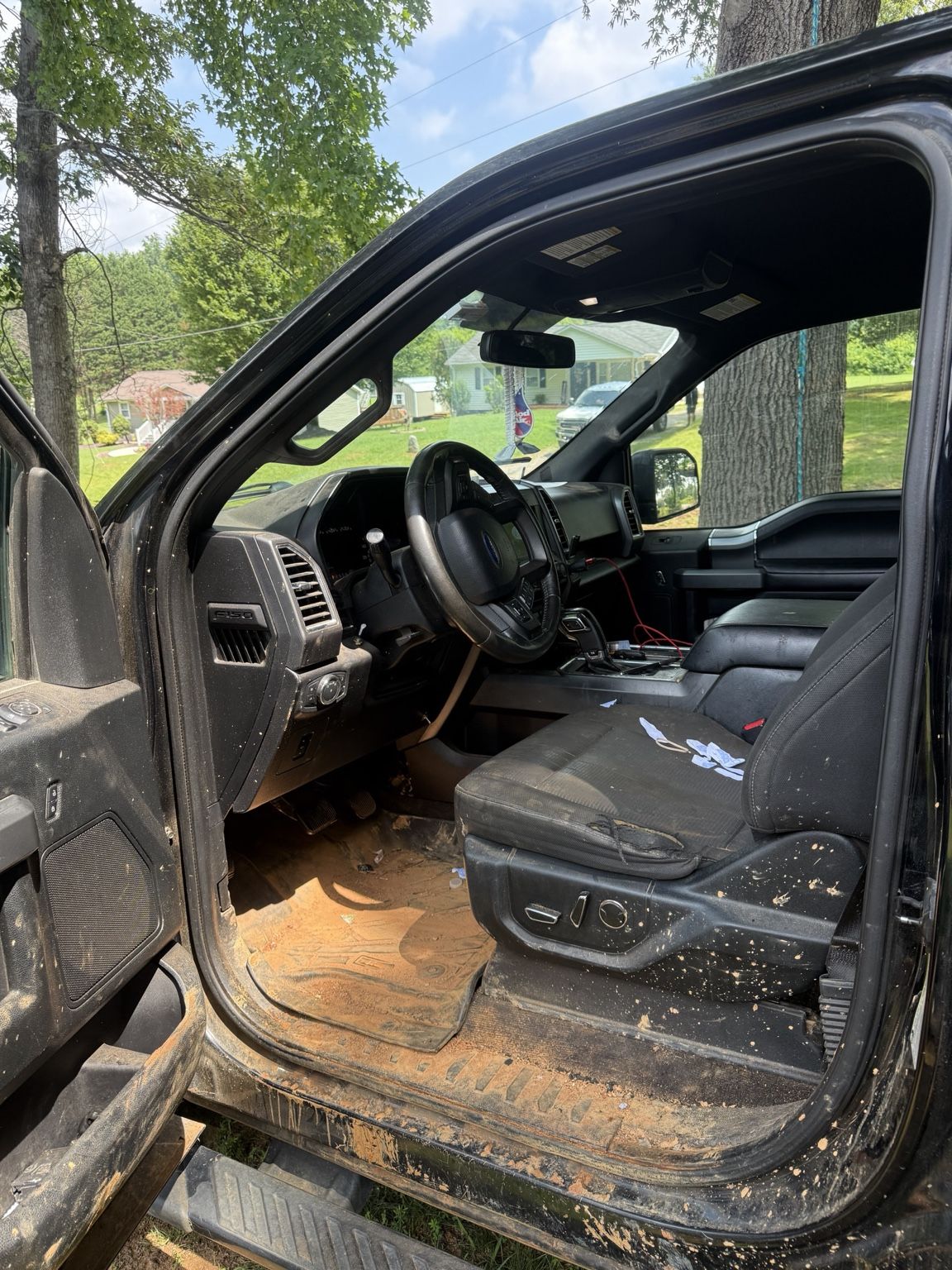Muddy truck front seat and driver area before detailing